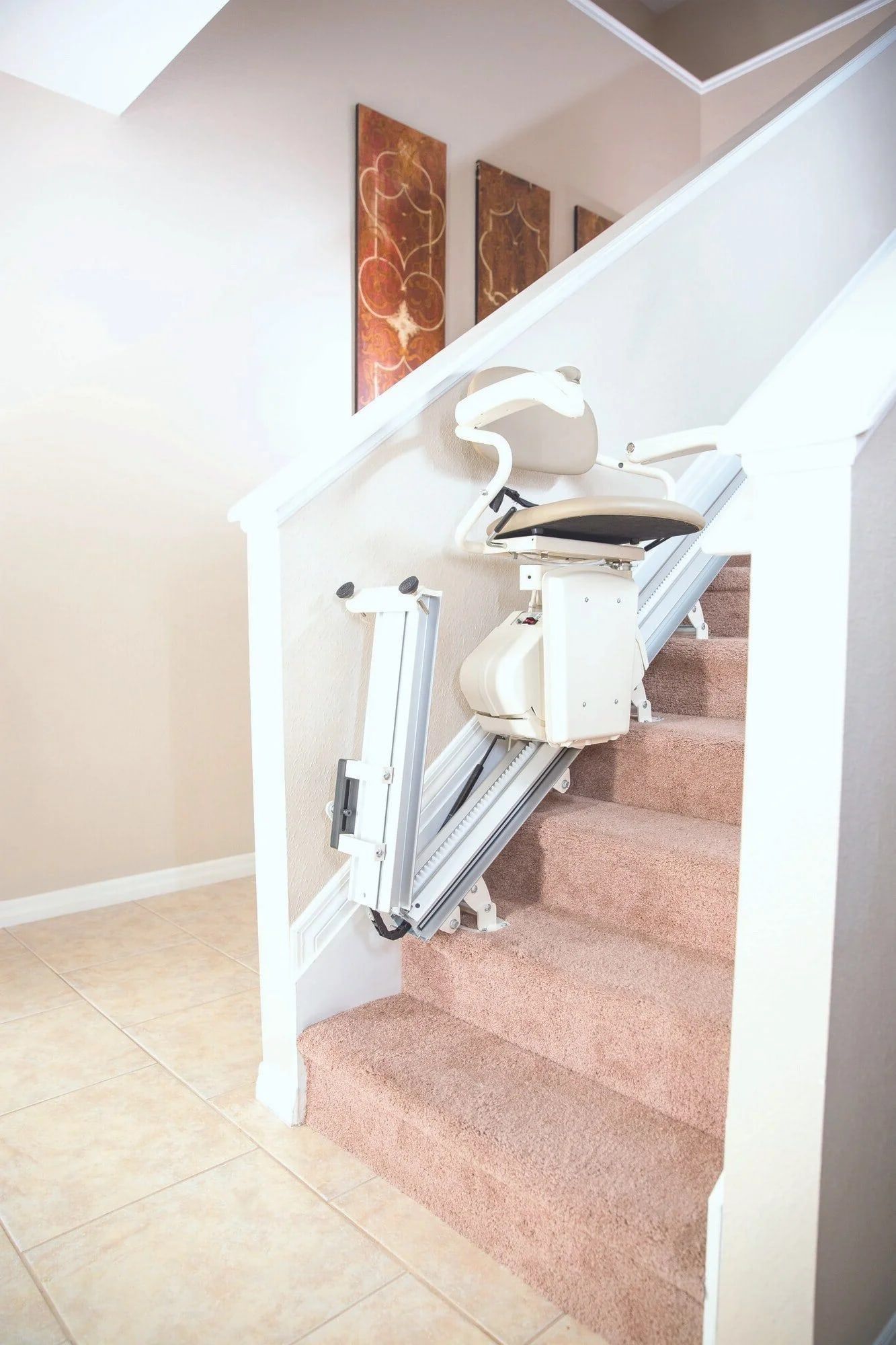 Harmar mechanical folding rail lifted at the bottom of a staircase