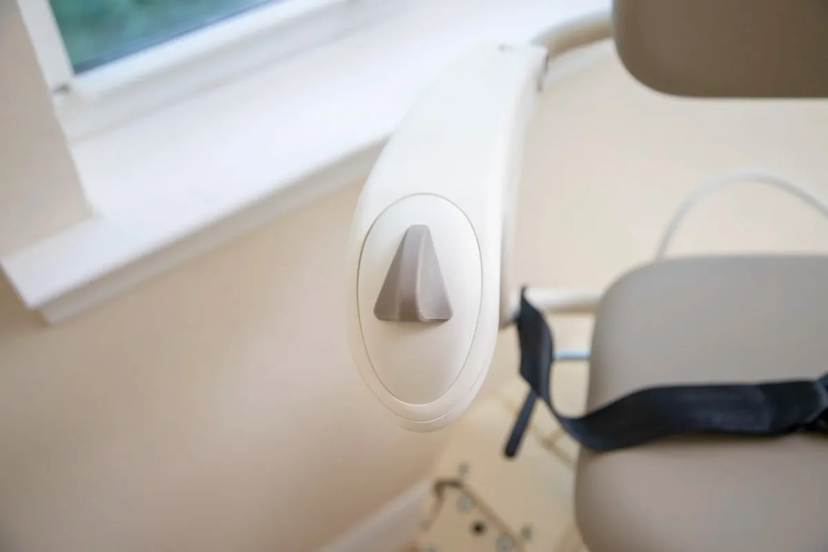 Harmar Pinnacle SL300 stairlift on a staircase beside a window