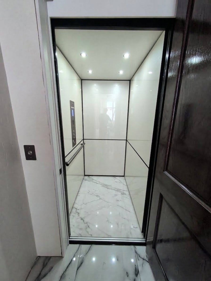 Savaria elevator cab with white walls and marble floor in Bedford, PA