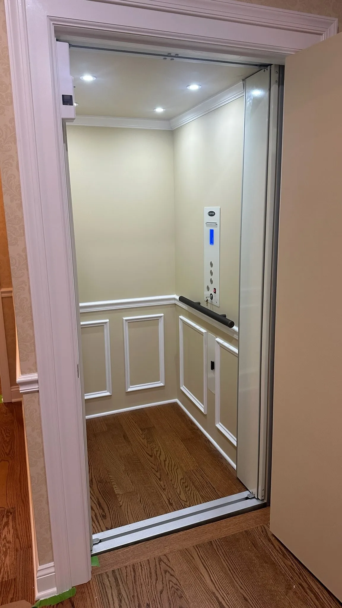 Home elevator cab with white wainscoting and recessed lighting installed in York, PA