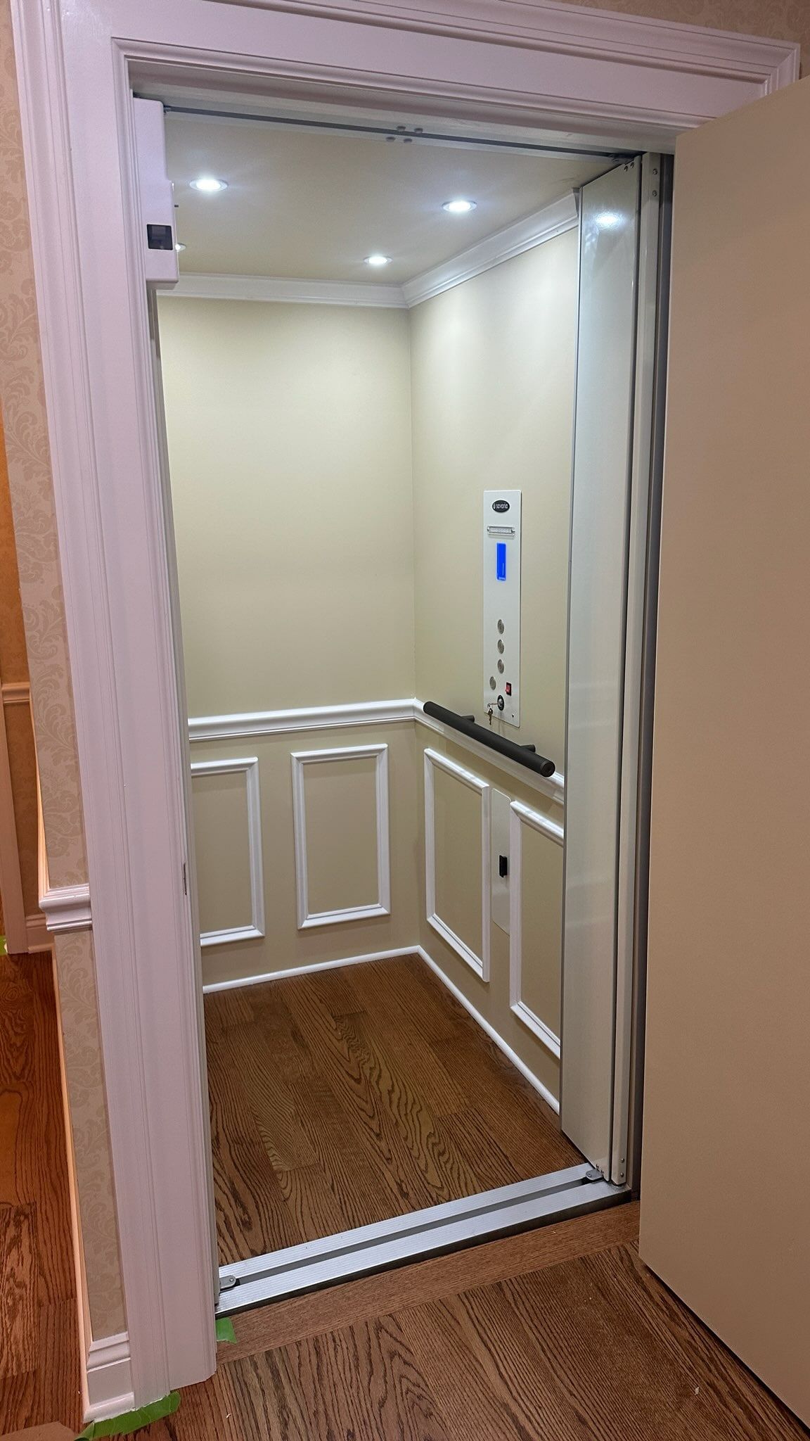 Home elevator cab with white wainscoting and recessed lighting installed in York, PA