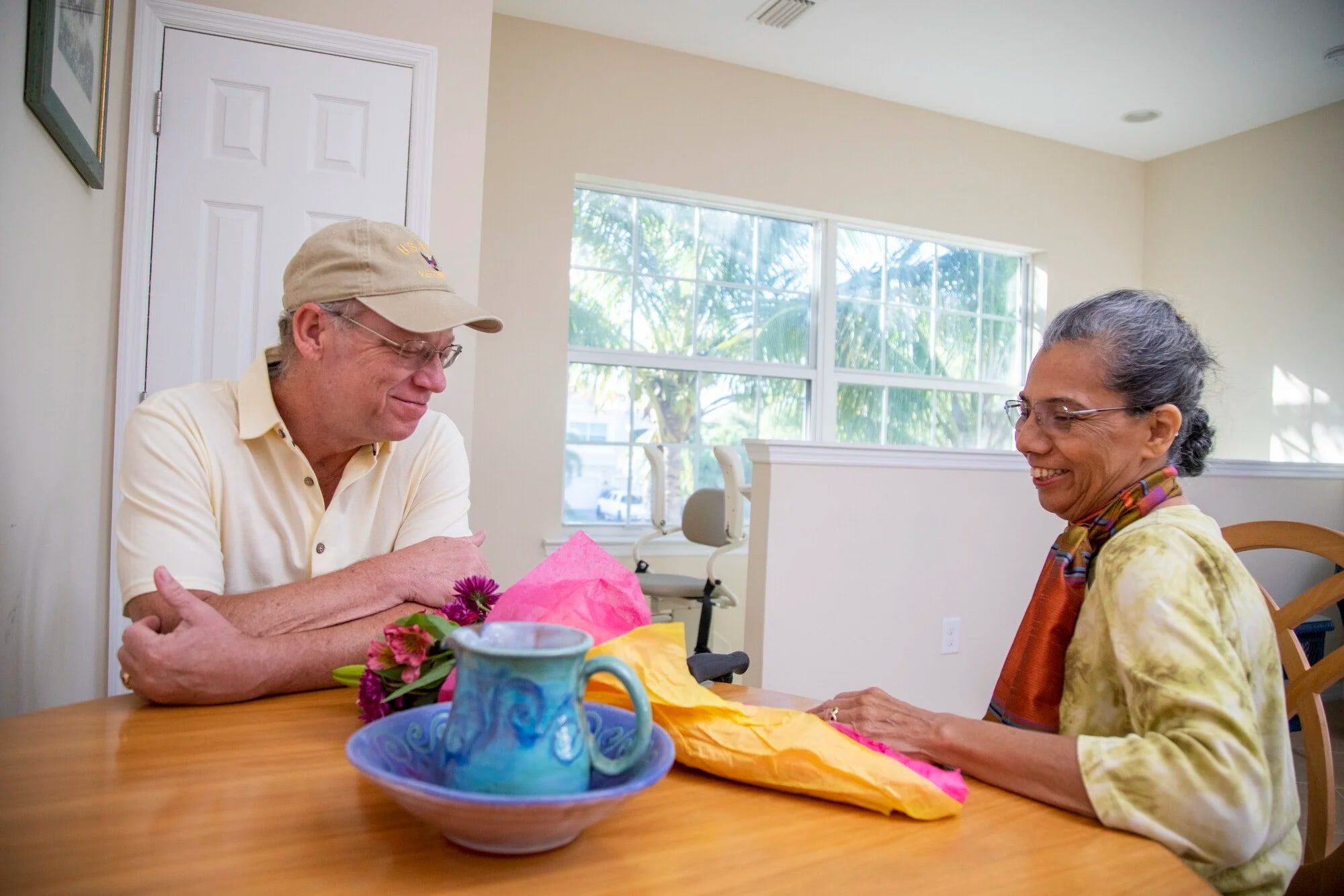 Sitting down at a kitchen table during a free in-home stairlift consultation