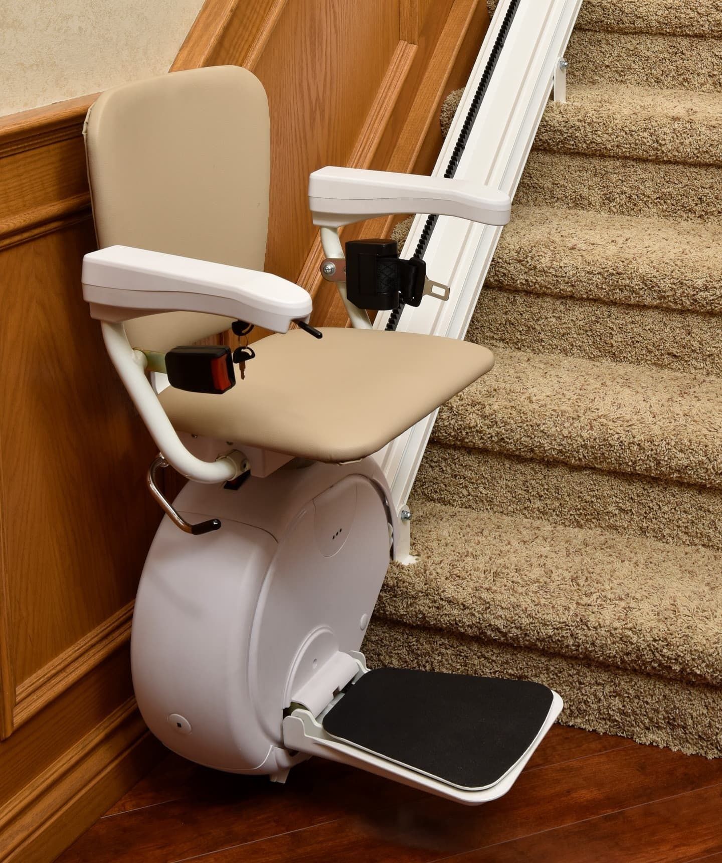 Savaria K2 straight stairlift with beige seat on a carpeted staircase