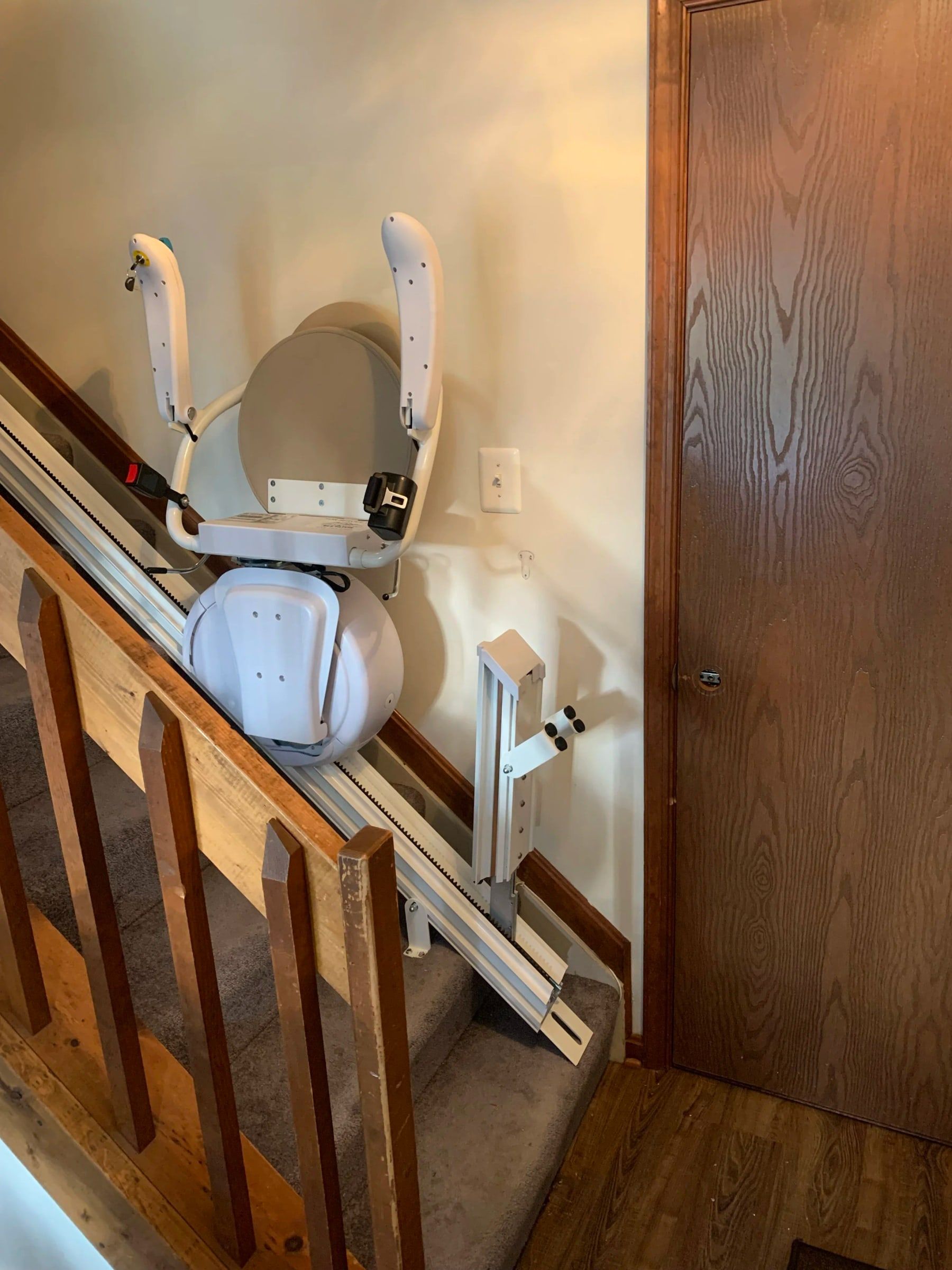 Savaria K2 with the folding rail option raised at the bottom of the stairs