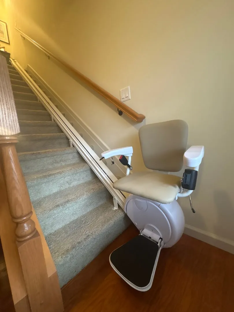 Savaria K2 stairlift on a carpeted staircase