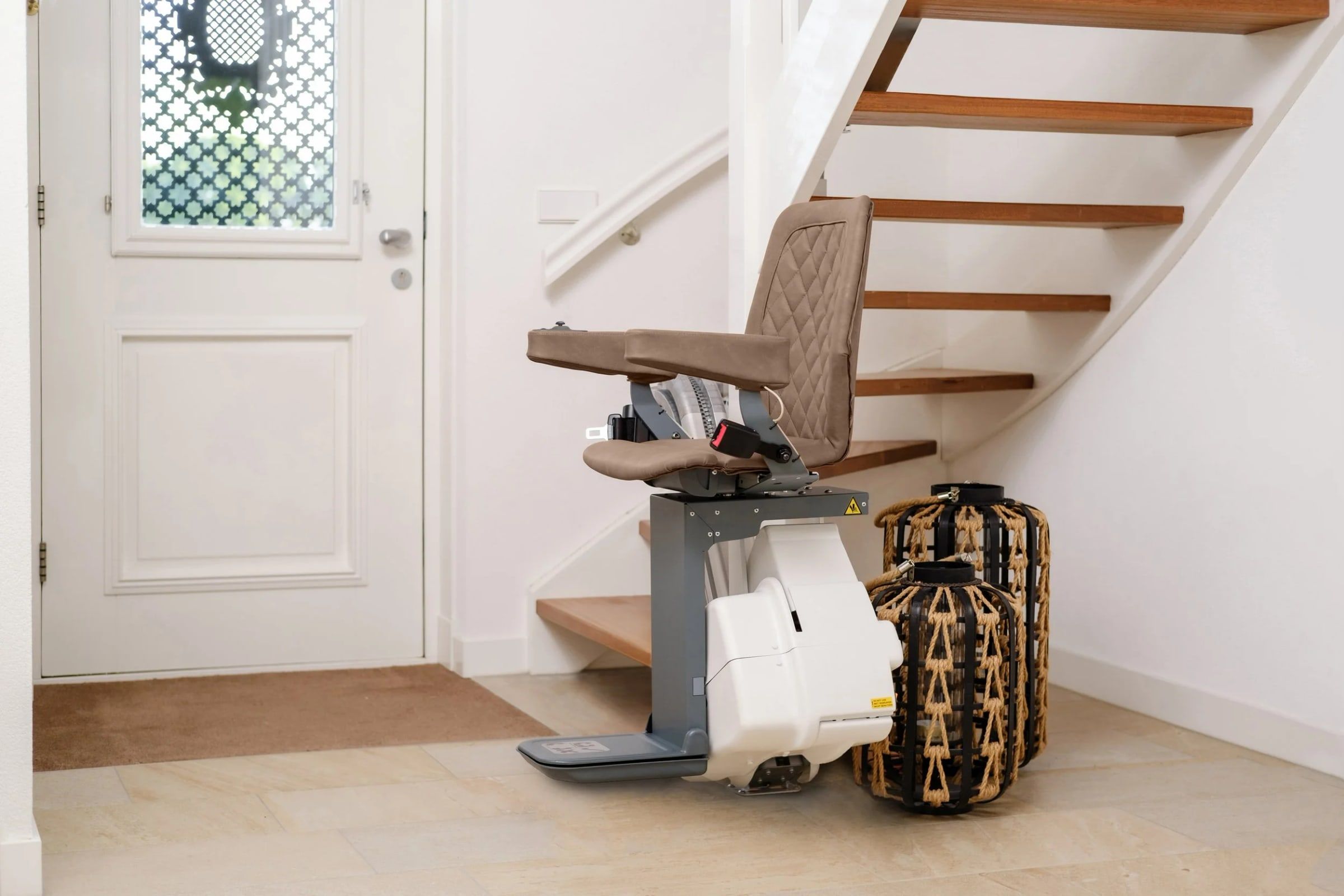 UP Stairlift in sand upholstery riding a curved rail