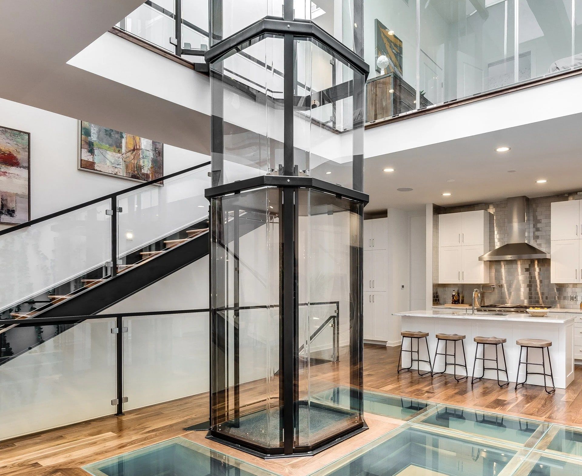 Savaria Vuelift octagonal glass elevator in a wood-trimmed home